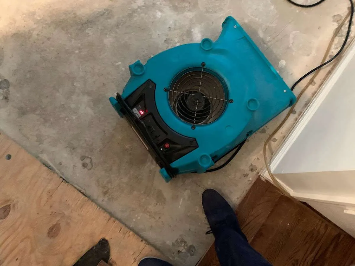 Air mover drying subfloor during Leak Detection & Repair in West Melbourne